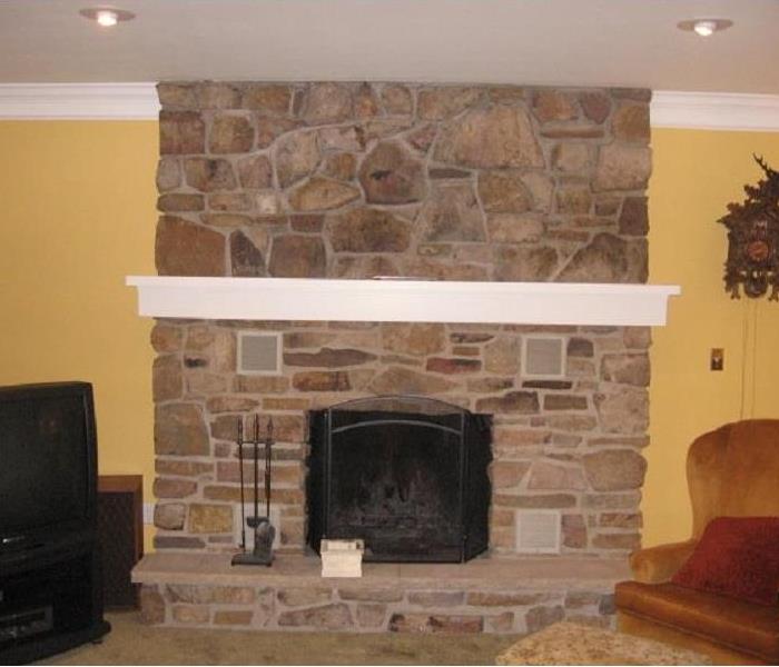 Stone fireplace cleaned with a reconstructed mantle