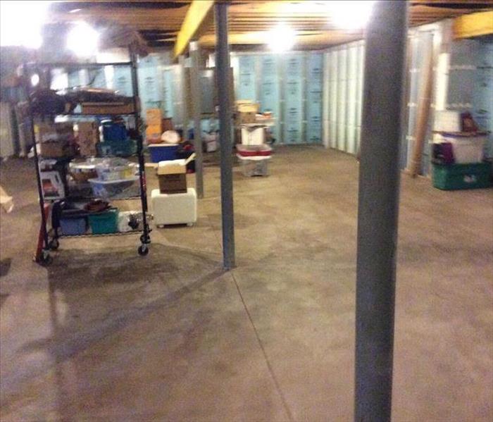 Dry concrete floor in basement with contents